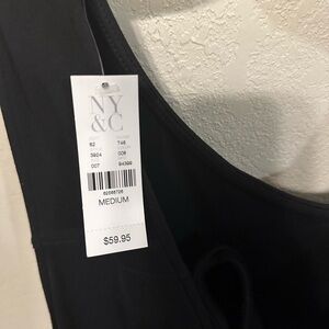 Black shorts romper from New York and Company. Tie back w/pockets. Med